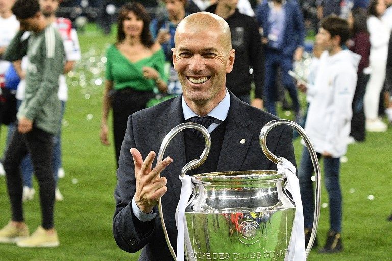 Real Madrid's French coach Zinedine Zidane poses with the trophy after winning  the UEFA Champions League final football match between Liverpool and Real Madrid at the Olympic Stadium in Kiev, Ukraine, on May 26, 2018. / AFP PHOTO / GENYA SAVILOV