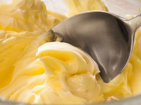 Butter cream Icing being made by mixing butter and icing sugar, part of making a cake series