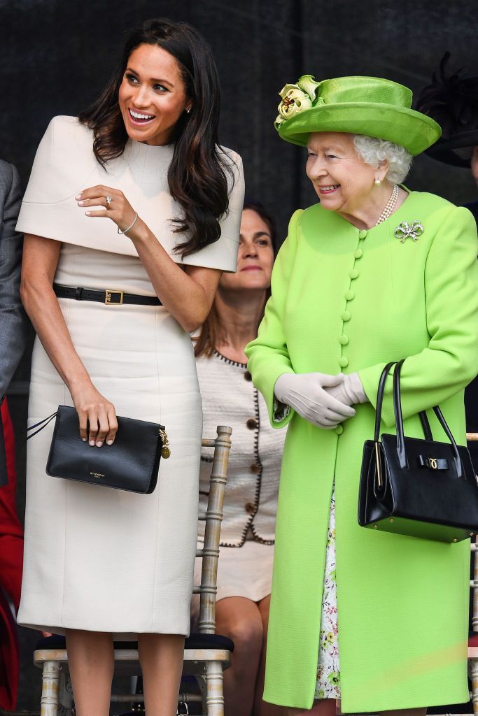 RUNCORN, CHESHIRE, ENGLAND - JUNE 14:  Queen Elizabeth II is greeted with Meghan, Duchess of Sussex as they arrive by Royal Train at Runcorn Station to open the new Mersey Gateway Bridge on June 14, 2018 in the town of Runcorn, Cheshire, England. Meghan Markle married Prince Harry last month to become The Duchess of Sussex and this is her first engagement with the Queen. During the visit the pair will open a road bridge in Widnes and visit The Storyhouse and Town Hall in Chester.  (Photo by Peter Byrne - WPA Pool/Getty Images)