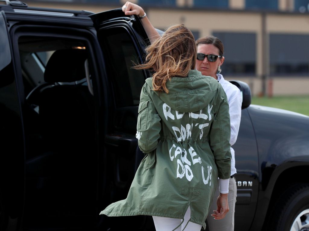 U.S. first lady Melania Trump climbs into her motorcade vehicle wearing a Zara design jacket with the phrase 