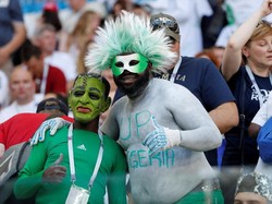 Pendukung Nigeria ini menggunakan topeng dan rambut palsu untuk memeriahkan tampilannya saat mendukung timnas kebanggaannya. Istimewa/Toru Hanai/Reuters.