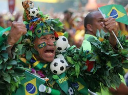 Suporter Brasil ini mengunakan kostum dari daun dengan berbagai hiasan bola dan bendera Brasil saat menonton pertandingan Brasil melawan Kosta Rika. Istimewa/Sergio Moraes/Reuters.