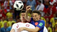 Lewandowski dalam duel udara dengan bek kanan Kolombia, Santiago Arias. Foto: Sergio Perez/Reuters