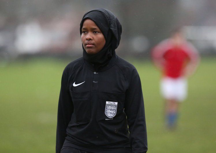 *** EXCLUSIVE - VIDEO AVAILABLE ***  WEMBLEY, UNITED KINGDOM - FEBRUARY 2018: JJ refereeing an all male 11-a-side football match in Wembley, England.  CONDITION OF USAGE: The following must be included in print and/or online: JJ?s story will feature in The History of Football global TV event, airing on History (excluding USA, Canada, Australia, New Zealand), from May 28th-10th June 2018. AS her first full season as a Football Association-registered official draws to a close, Jawahir Roble has made history as the first Muslim female referee in the UK. Having always loved football, JJ made the decision to pursue refereeing more seriously after studying for coaching badges as a teenager. A local girl?s league was short of match officials and JJ stepped in, eventually going on to do a refereeing course. JJ?s love of the beautiful game goes back to her childhood. Among the rubble of the Mogadishu streets, JJ would play football with her friends and siblings. Pleading with her parents to stay out beyond their curfew so she could play football for longer, JJ wasn?t so much oblivious to the dangers of war as conditioned to it. JJ?s incredible story will feature in The History of Football global TV event, airing on History (excluding USA, Canada, Australia, New Zealand), from May 28th-10th June 2018.  PHOTOGRAPH BY Barcroft Images / HISTORYÆ