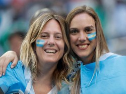 Dua suporter Argentina pamerkan senyum cantik rayakan kemenangan Messi cs. Toru Hanai/Reuters.