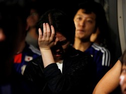 Para suporter Jepang pun harus mengakui kekalahan timnas kebanggaan mereka. Issei Kato/Reuters.