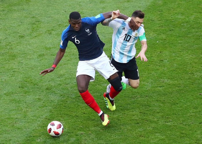 Soccer Football - World Cup - Round of 16 - France vs Argentina - Kazan Arena, Kazan, Russia - June 30, 2018  Frances Paul Pogba in action with Argentinas Lionel Messi   REUTERS/Pilar Olivares