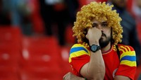 Fans Kolombia ini cuma bisa duduk termangu melihat perayaan kemenangan ada di kubu lawan. Reuters/Carl Recine.