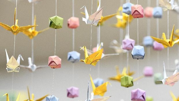 The photo illustration shows cranes and ornaments made from the paper-folding craft of origami, at the Origami Kaikan Hall in Tokyo on February 20, 2018. / AFP PHOTO / TORU YAMANAKA