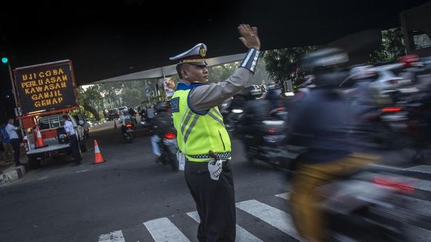 Polisi mengatur arus lalu lintas pada hari pertama uji coba perluasan kawasan ganjil genap di persimpangan Pancoran, Jakarta, Senin (2/7). Perluasan kawasan lalu lintas ganjil genap di sejumlah ruas jalan di Ibu Kota mulai pukul 06.00 WIB hingga pukul 21.00 WIB yang saat ini dalam tahap uji coba itu akan diberlakukan mulai 1 Agustus 2018 guna mendukung kelancaran arus lalu lintas pada penyelenggaraan Asian Games 2018. ANTARA FOTO/Aprillio Akbar/aww/18.