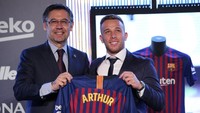 Didampingi Presiden Barca, Arthur tampak semringah memamerkan jersey klub barunya yang berwarna merah biru. (Foto: Albert Gea/Reuters)
