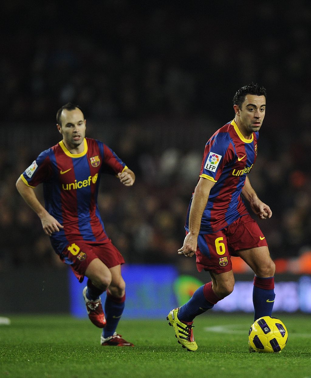 BARCELONA, SPAIN - JANUARY 12:  Xavi Hernandez of FC Barcelona (R) and his teammate Andres Iniesta in action during the Copa del Rey quarter final first leg match between FC Barcelona and Betis at Camp Nou on January 12, 2011 in Barcelona, Spain. Barcelona won 5-0.  (Photo by David Ramos/Getty Images)