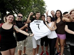 Fans Juventus merayakan kedatangan Ronaldo ke Turin dengan jersey bernomor punggung 7 yang sebelumnya dikenakan oleh Juan Cuadrado. (Foto: Isabella Bonotto/AFP)