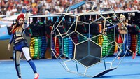 Para penari menampilkan tarian di atas lapangan yang disulap menjadi warna biru. Reuters/Kai Pfaffenbach.