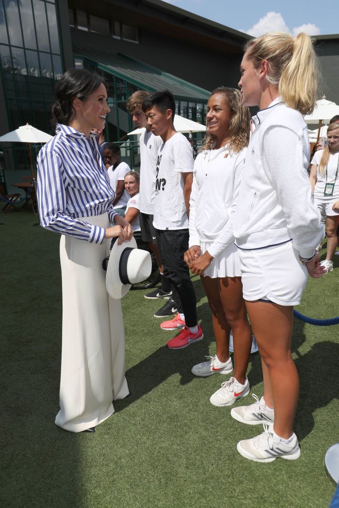 LONDON, ENGLAND - JULY 14: Meghan, Duchess of Sussex meets junior players Whitney Osuigwe of the United States and Caty McNally of the United States during a visit to the Wimbledon Championships at All England Lawn Tennis and Croquet Club on July 14, 2018 in London, England. (Photo by Jonathan Brady - WPA Pool/Getty Images)