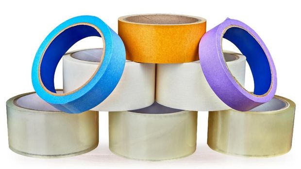 Set of adhesive tapes for various purposes, folded in the form of a pyramid, isolated on white background with saved clipping path.