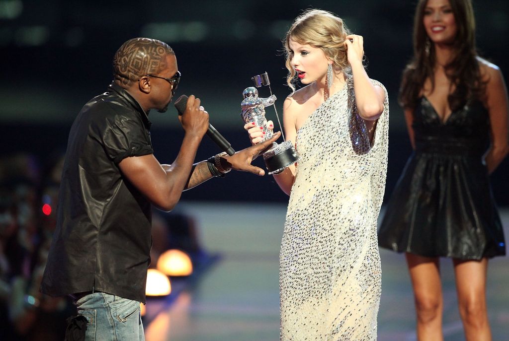 NEW YORK - SEPTEMBER 13:   Kanye West (L) jumps onstage after Taylor Swift (C) won the 