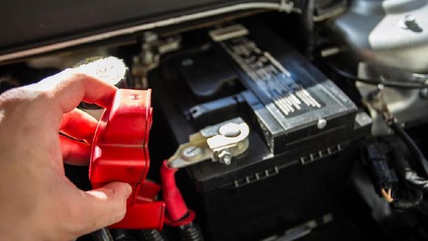 Mechanic checking car battery