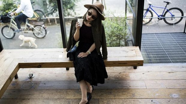 In this photo taken on October 12, 2016,Japanese fashion designer Yayoi Maeda drinks her beverage in a coffee shop in Tokyo.In a country famous for its tea, the Japanese are increasingly turning to coffee as a quick-fix to help ease the daily grind. Hipster cafÃˆs are popping up everywhere, offering exquisitely curated beverages to satisfy even the fussiest of caffeine addicts. / AFP PHOTO / BEHROUZ MEHRI / TO GO WITH AFP STORY JAPAN-LIFESTYLE-COFFEE-CULTURE,FEATURE BY ALASTAIR HIMMER
