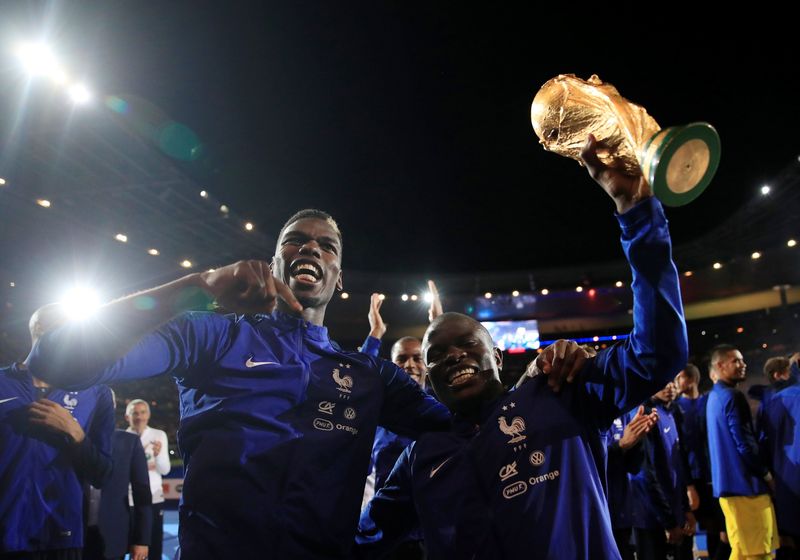 Soccer Football - UEFA Nations League - League A - Group 1 - France v Netherlands - Stade de France, Saint-Denis, France - September 9, 2018 France's N'Golo Kante and Paul Pogba celebrate with the World Cup trophy during a ceremony after the match REUTERS/Gonzalo Fuentes