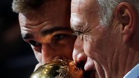 Antoine Griezmann dan pelatih Didier Deschamps mencium trofi Piala Dunia. Sukses di Rusia melengkapi performa mengilap Griezmann yang juga memenangi Liga Europa dan Piala Super Eropa bersama Atletico Madrid. Foto: Charles Platiau/Reuters