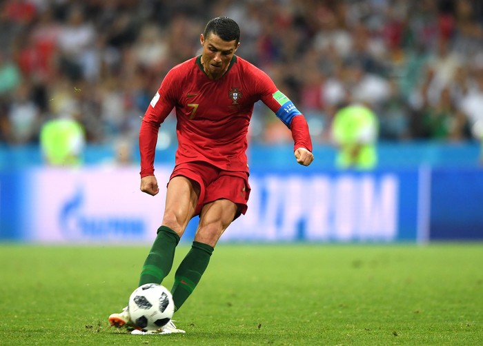 Cristiano Ronaldo SOCHI, RUSSIA - JUNE 15: Cristiano Ronaldo of Portugal scores a free-kick for his team's third goal during the 2018 FIFA World Cup Russia group B match between Portugal and Spain at Fisht Stadium on June 15, 2018 in Sochi, Russia. (Photo by Stu Forster/Getty Images)