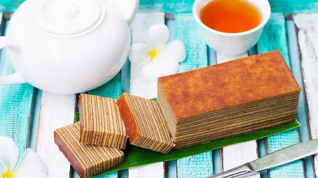 Kue Lapis Traditional Indonesian sweet Lapis layer cake on a wooden background.