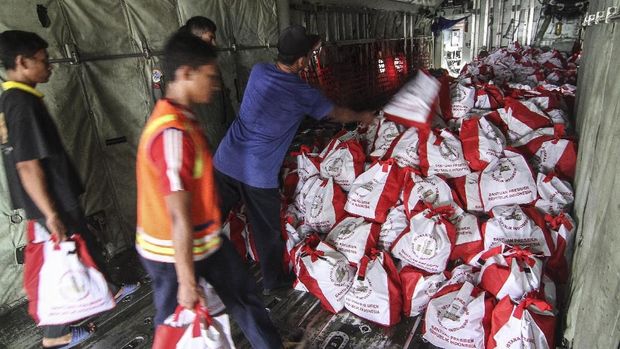 Sejumlah petugas memindahkan paket bantuan dari Presiden Joko Widodo untuk korban gempa dan tsunami Palu, di Lanud Halim Perdanakusuma, Jakarta, Senin (1/10).