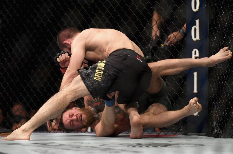 LAS VEGAS, NV - OCTOBER 06: Khabib Nurmagomedov of Russia (top) punches Conor McGregor of Ireland in their UFC lightweight championship bout during the UFC 229 event inside T-Mobile Arena on October 6, 2018 in Las Vegas, Nevada.   Harry How/Getty Images/AFP