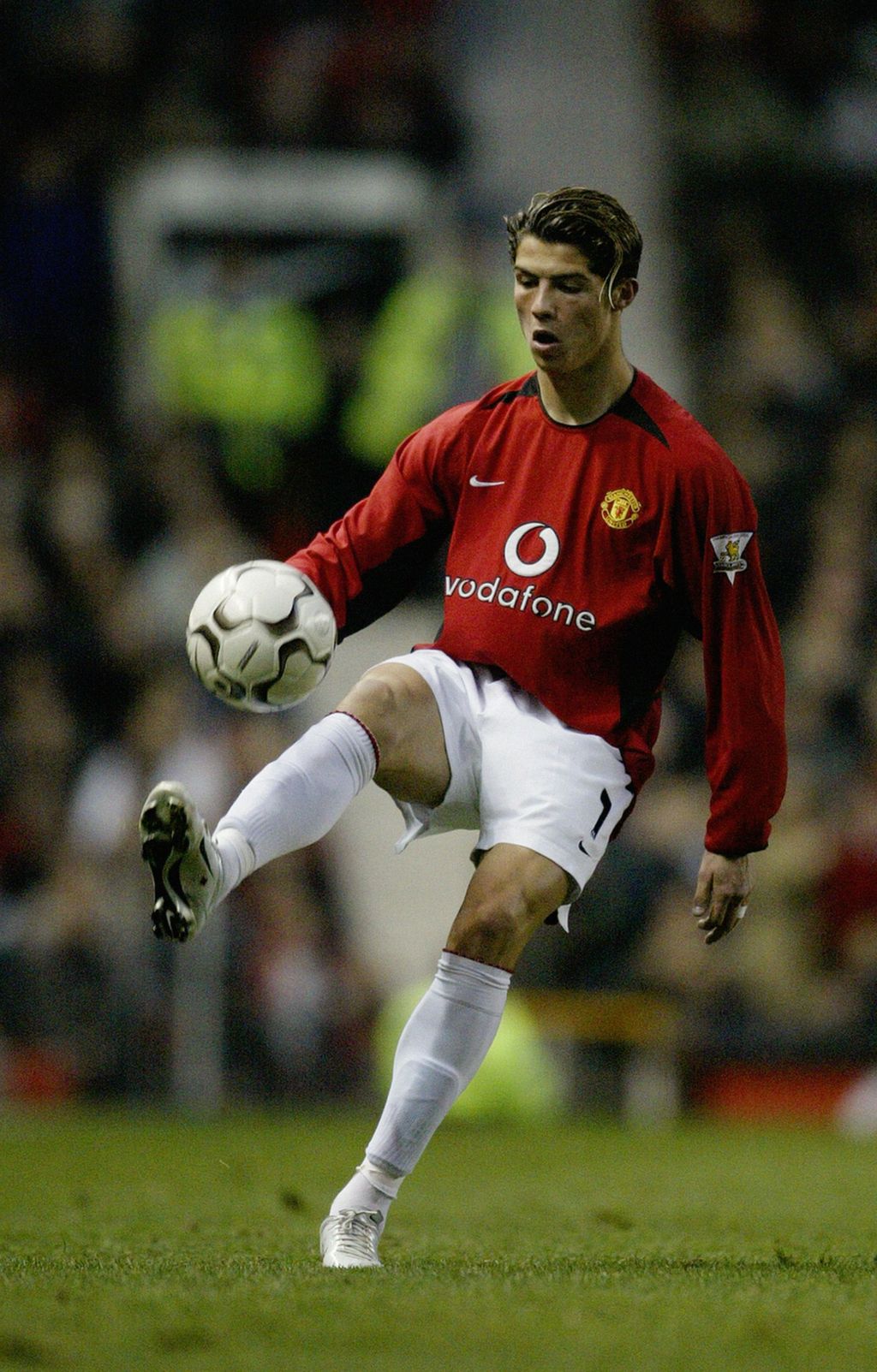 MANCHESTER - NOVEMBER 1:  Cristiano Ronaldo of Manchester United takes control of the ball during the FA Barclaycard Premiership match between Manchester United and Portsmouth on November 1, 2003 at Old Trafford in Manchester, England.  Manchester United won the match 3-0. (Photo by Alex Livesey/Getty Images)