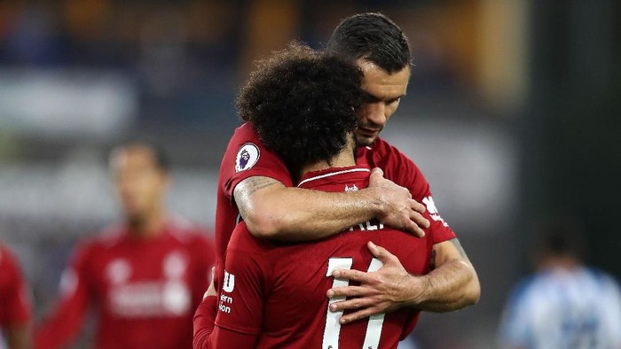 HUDDERSFIELD, ENGLAND - OCTOBER 20: Mohamed Salah of Liverpool(back) celebrates after scoring his sides first goal with Dejan Lovren of Liverpool during the Premier League match between Huddersfield Town and Liverpool FC at John Smiths Stadium on October 20, 2018 in Huddersfield, United Kingdom. (Photo by Mark Robinson/Getty Images)