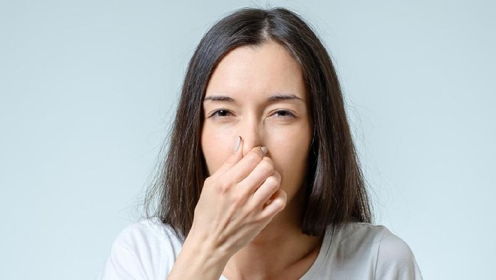 Young Woman Noticed Smell Coming From Dishwasher In Kitchen