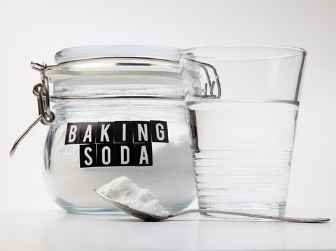 Spoonful of baking soda and glass of water