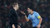 Luis Suarez memprotes keputusan wasit. Reuters/Peter Cziborra.