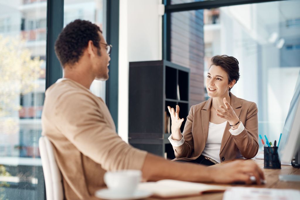 Young cheerful businesswoman listening music in headphones at office.