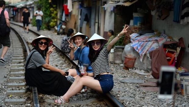 Wisatawan antusias untuk berswafoto di rel kereta di Hanoi.