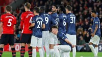 Scott McTominay jongkok di belakang pagar hidup untuk mengantisipasi tendangan bebas. (Foto: Eddie Keogh/Reuters)