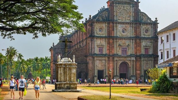 Old Goa, India - November 13, 2012: Unidentified tourists visit to the famous landmark - Basilica of Bom Jesus (Borea Jezuchi Bajilika) in Old Goa, India. Basilica is a UNESCO World Heritage Site.