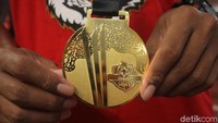 Para pemain memamerkan medali juara khas Liga 1.