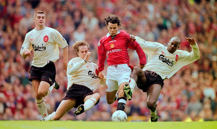 MANCHESTER, UNITED KINGDOM - OCTOBER 12:  Manchester United winger Ryan Giggs is challenged by Jason McAteer (2nd l) and Michael Thomas (r) as Dominic Matteo (l) looks on during the FA Premier League match between Manchester United and Liverpool at Old Trafford on October 12, 1996 in Mnachester, Engand. (Photo by Clive Brunskill/Allsport/Getty Images)