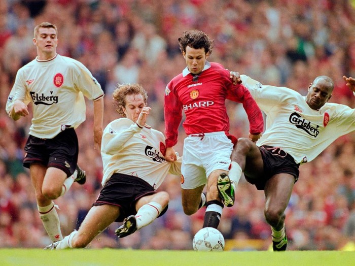 MANCHESTER, UNITED KINGDOM - OCTOBER 12:  Manchester United winger Ryan Giggs is challenged by Jason McAteer (2nd l) and Michael Thomas (r) as Dominic Matteo (l) looks on during the FA Premier League match between Manchester United and Liverpool at Old Trafford on October 12, 1996 in Mnachester, Engand. (Photo by Clive Brunskill/Allsport/Getty Images)