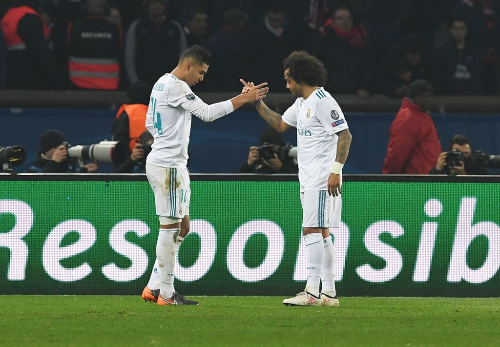 PARIS, FRANCE - MARCH 06:  Casemiro of Real Madrid (L) celebrates as he scores their second goal with Casemiro of Real Madrid celebrates as he scores their second goal with Cristiano Ronaldo during the UEFA Champions League Round of 16 Second Leg match between Paris Saint-Germain and Real Madrid at Parc des Princes on March 6, 2018 in Paris, France.  (Photo by Matthias Hangst/Getty Images)