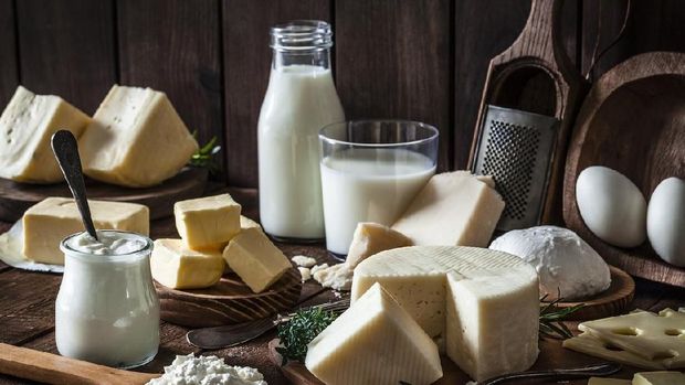 Dairy products assortment shot on rustic wooden table. Dairy products included are milk, yogurt, butter, goat cheese, mozzarella, ricotta, Parmesan cheese, emmental cheese, eggs and hard cheese. Low key DSRL studio photo taken with Canon EOS 5D Mk II and Canon EF 100mm f/2.8L Macro IS USM