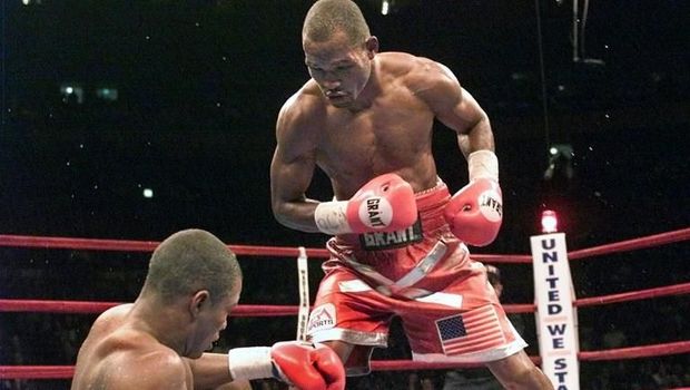 WBC-IBF Middleweight Champion Bernard Hopkins (R) of the US knocks down WBA Champion Felix Trinidad of Puerto Rico in the 11th round during their 12 round unification match at Madison Square Garden in New York 29 September, 2001. Hopkins won by technical knockout in the 12th round to secure the undisputed Middleweight Championship. AFP PHOTO Timothy A. Clary (Photo by TIMOTHY A. CLARY / AFP)