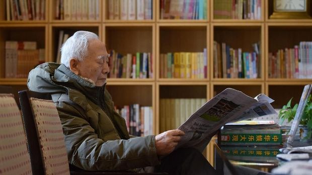 This photo taken on December 5, 2018 shows a resident reading in a library at the Yanyuan community for senior citizens, on the outskirts of Beijing. - As China's population ages rapidly and the one-child policy left parents with only a single child to help them in their old age, the upper crust of Chinese society are spending the last years of their lives in luxury. (Photo by GREG BAKER / AFP) / TO GO WITH China healthcare elderly,FEATURE by Eva Xiao