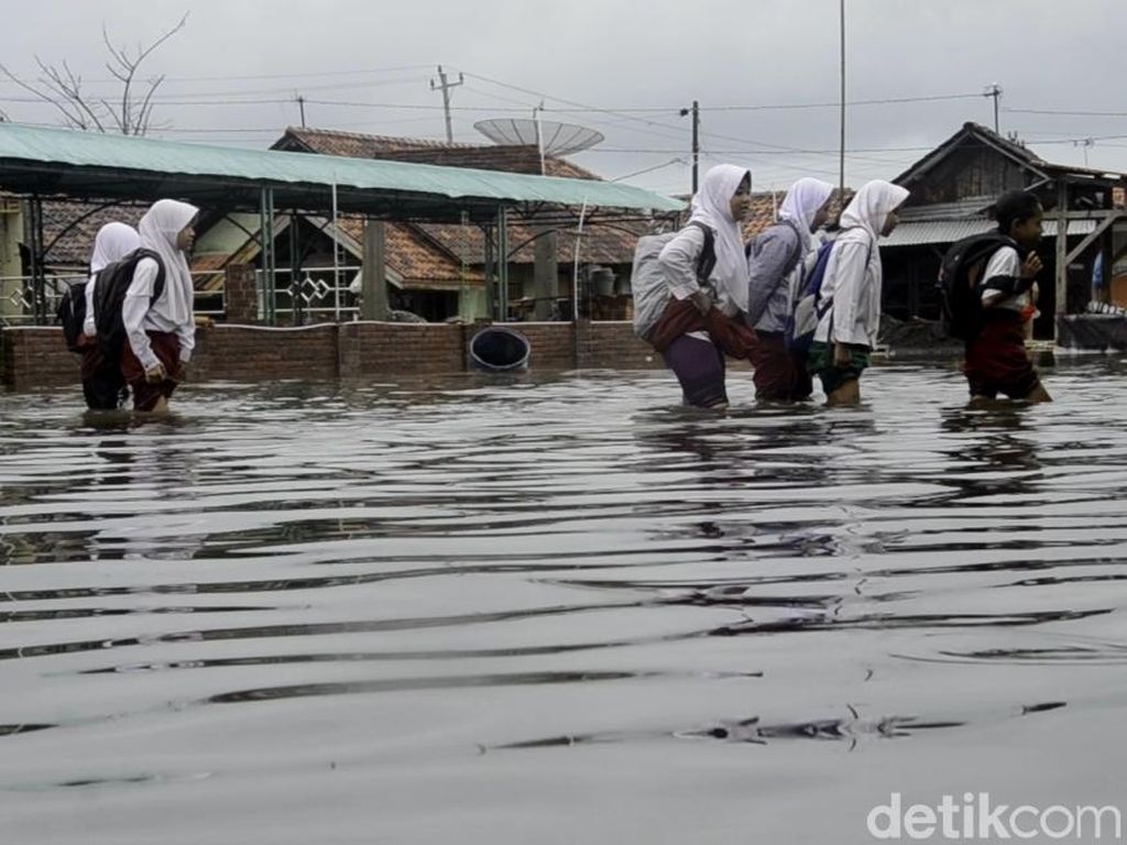 Potret Kegigihan Pelajar di Pekalongan Terobos Hujan dan Banjir Potret Kegigihan Pelajar di Pekalongan Terobos Hujan dan Banjir