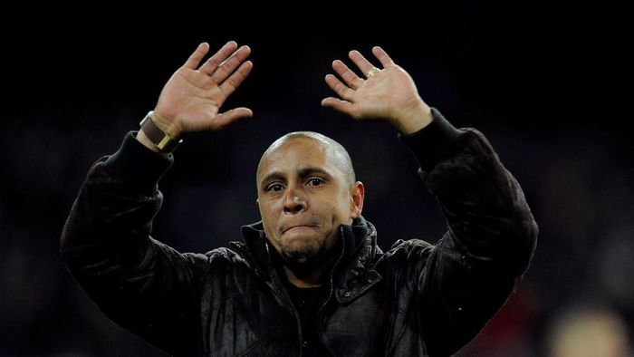 MADRID, SPAIN - FEBRUARY 12: Former Real Madrid player Roberto Carlos waves to supporters after he was presented with a trophy for his achievements at the club by president Florentino Perez during the La Liga match between Real Madrid and Levante at Estadio Santiago Bernabeu on February 12, 2012 in Madrid, Spain. (Photo by Denis Doyle/Getty Images)