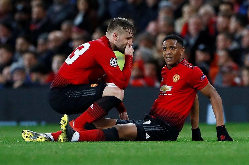 Soccer Football - Champions League Round of 16 First Leg - Manchester United v Paris St Germain - Old Trafford, Manchester, Britain - February 12, 2019  Manchester United's Anthony Martial goes down after sustaining an injury as Luke Shaw talks to him  Action Images via Reuters/Jason Cairnduff