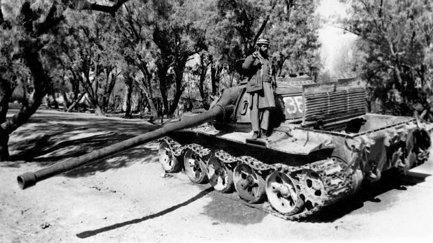 Mengenang 30 Tahun Berakhirnya Perang Soviet dan Afghanistan A Mujahideen (mujahidin) stands on a Soviet tank on February 7, 1989 in Torkham, east of Jalalabad, after its capture. (Photo by AFP)