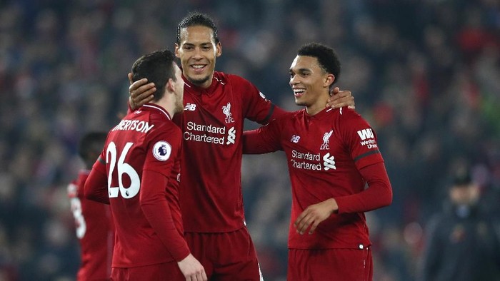 LIVERPOOL, ENGLAND - FEBRUARY 27: Virgil van Dijk of Liverpool celebrates victory with Trent Alexander-Arnold of Liverpool and Andy Robertson of Liverpool after the Premier League match between Liverpool FC and Watford FC at Anfield on February 27, 2019 in Liverpool, United Kingdom. (Photo by Clive Brunskill/Getty Images)